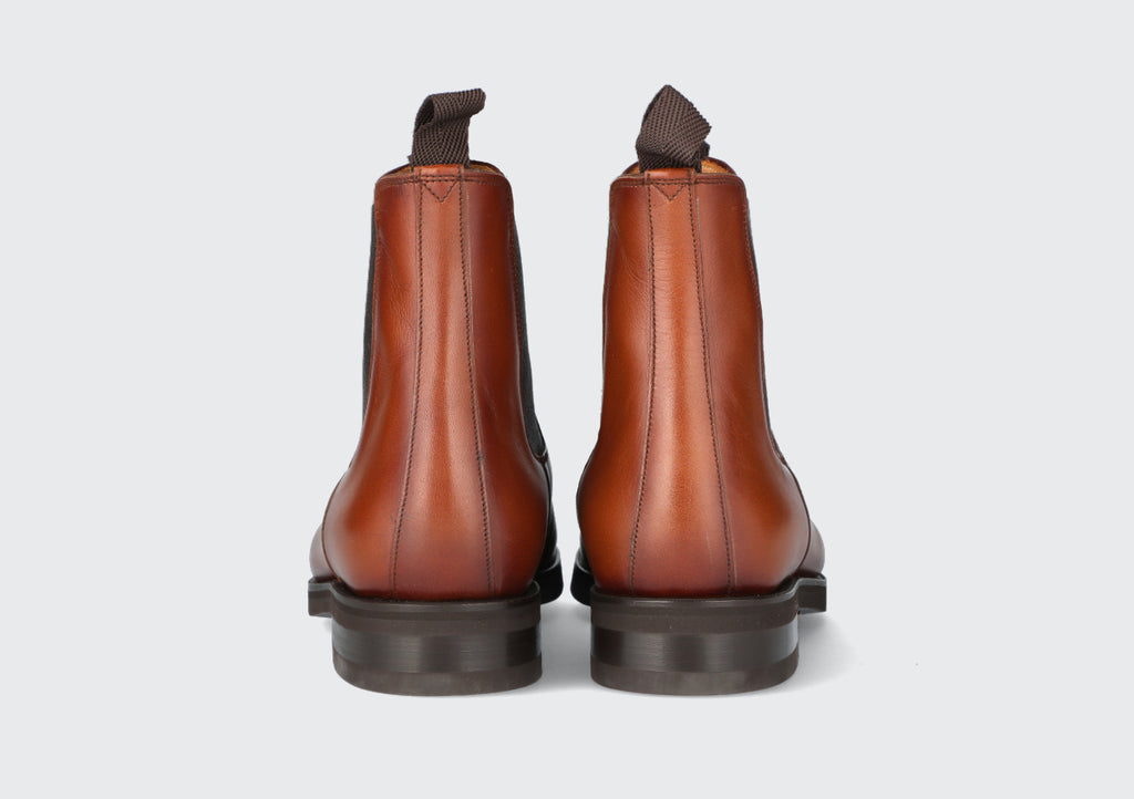 The heels of a pair of brown leather chelsea boots from the hartt shoe company