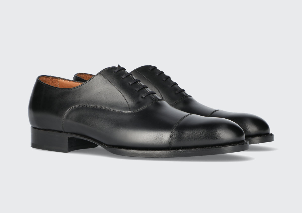 A pair of men's black leather dress shoes from the Hartt Shoe Company