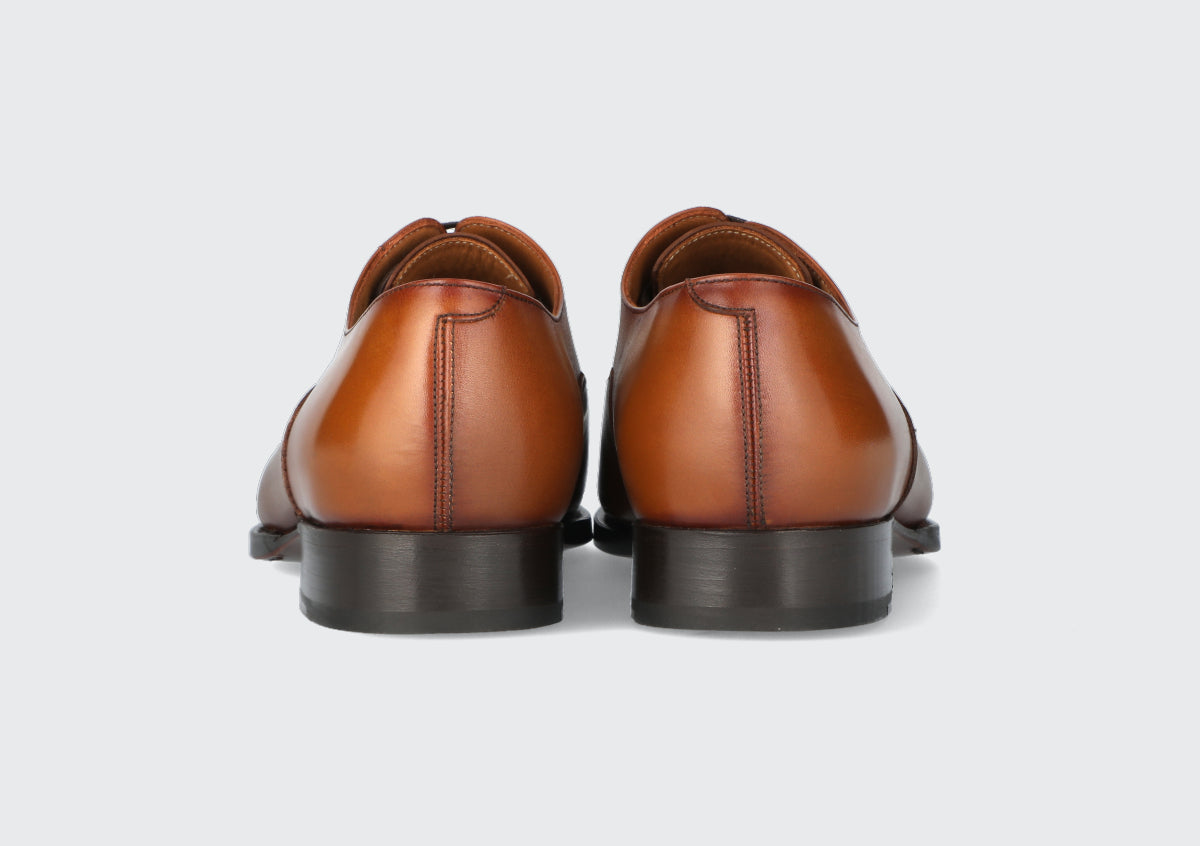 The heels of a pair of brown leather dress shoes from the Hartt Shoe Company