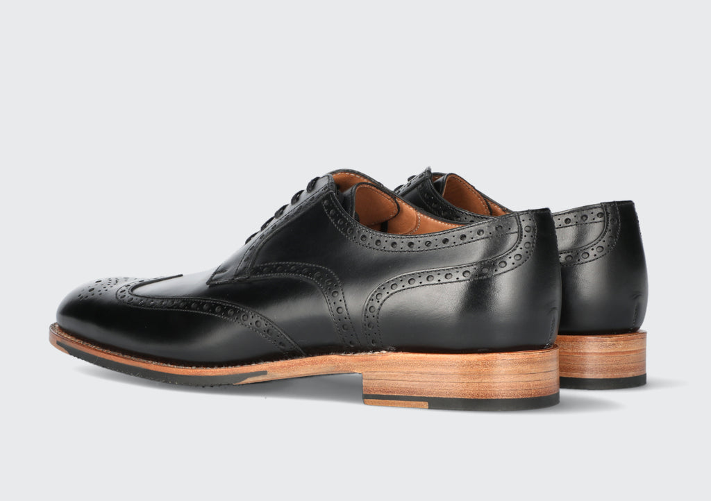 A pair of black leather men's dress shoes from the Hartt Shoe Company