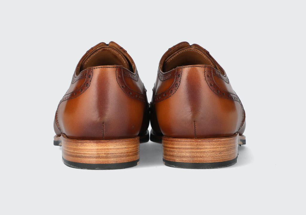 The heels of a pair of brown leather derbies from the Hartt Shoe Company