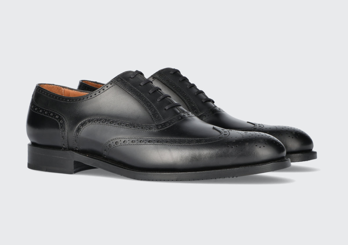 A pair of men's black leather dress shoes from the Hartt Shoe Company