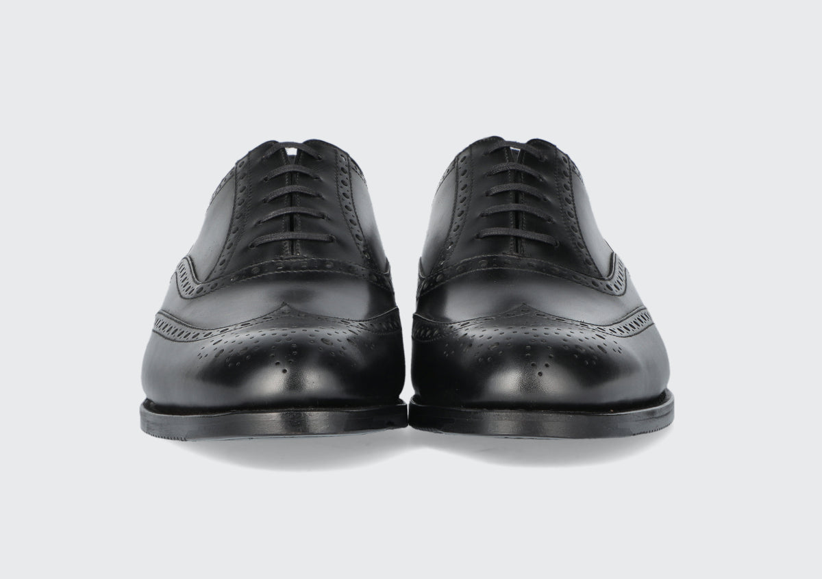 A front of a pair of black leather dress shoes from the Hartt Shoe Company