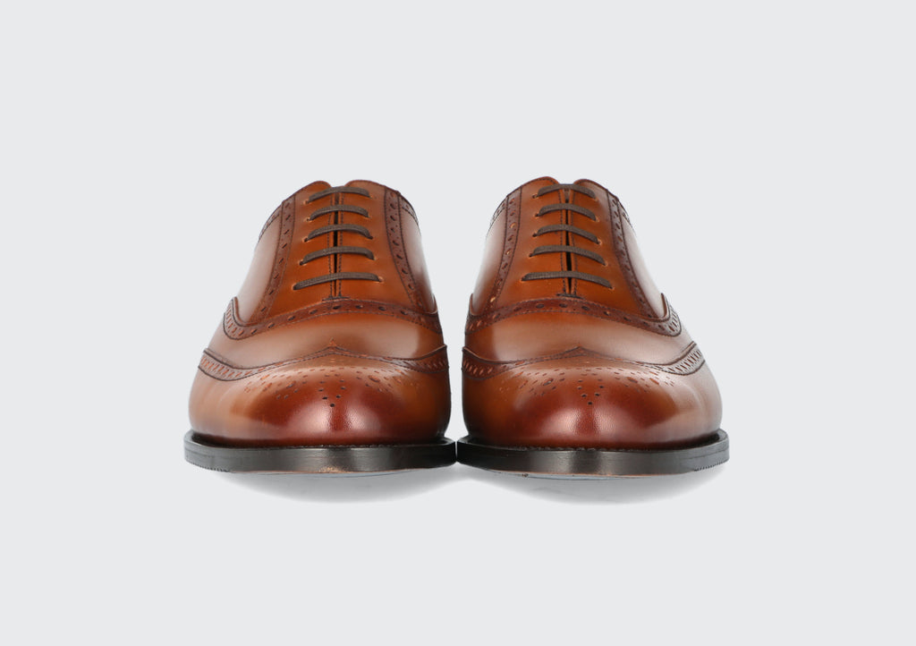 The front of a pair of brown leather men's dress shoes from the Hartt Shoe Company